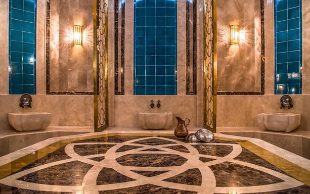 Private historical hammam bath interior with marble and blue tiles in Cappadocia, Turkey.