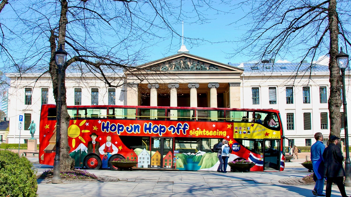 Hop on hop off bus near University of Oslo, showcasing city tour experience.