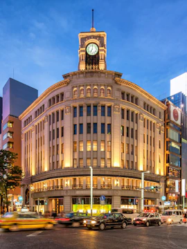 Wako Department Store with clock tower in Ginza, Tokyo, at dusk.
