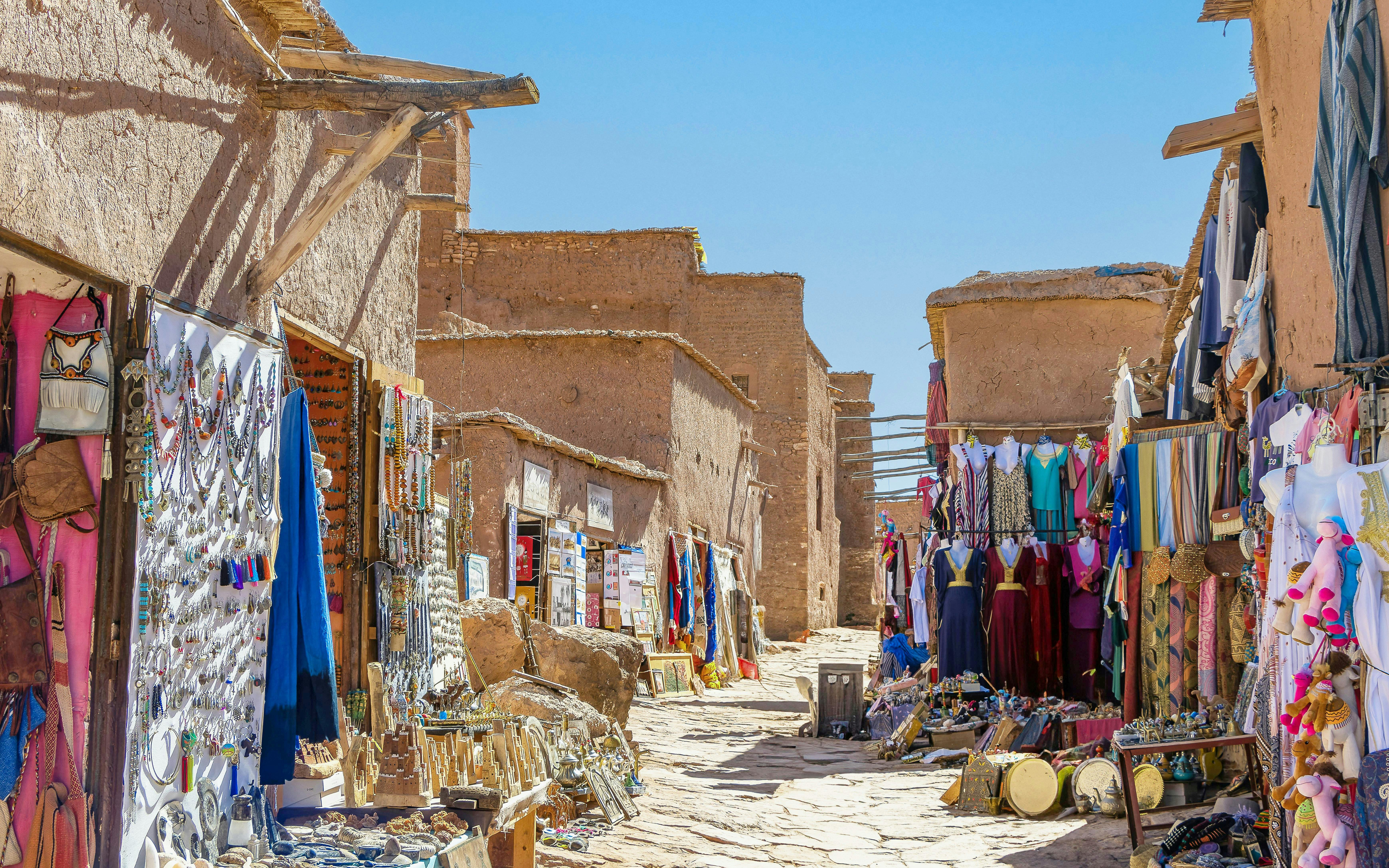 Souvenir shops with carpets and traditional clothes in Ait Ben Haddou, Morocco.
