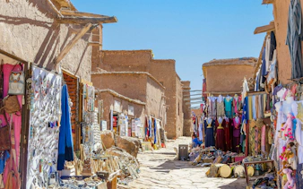 Souvenir shops with carpets and traditional clothes in Ait Ben Haddou, Morocco.