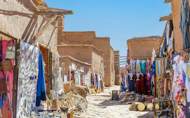 Souvenir shops with carpets and traditional clothes in Ait Ben Haddou, Morocco.