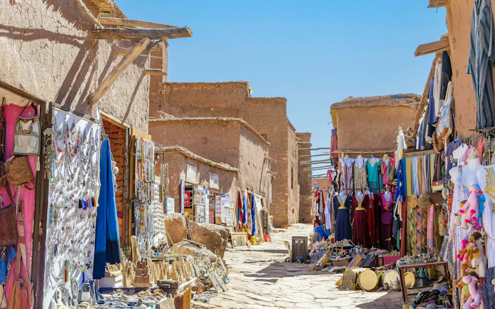 Souvenir shops with carpets and traditional clothes in Ait Ben Haddou, Morocco.
