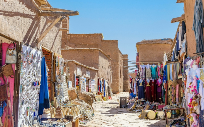 Souvenir shops with carpets and traditional clothes in Ait Ben Haddou, Morocco.