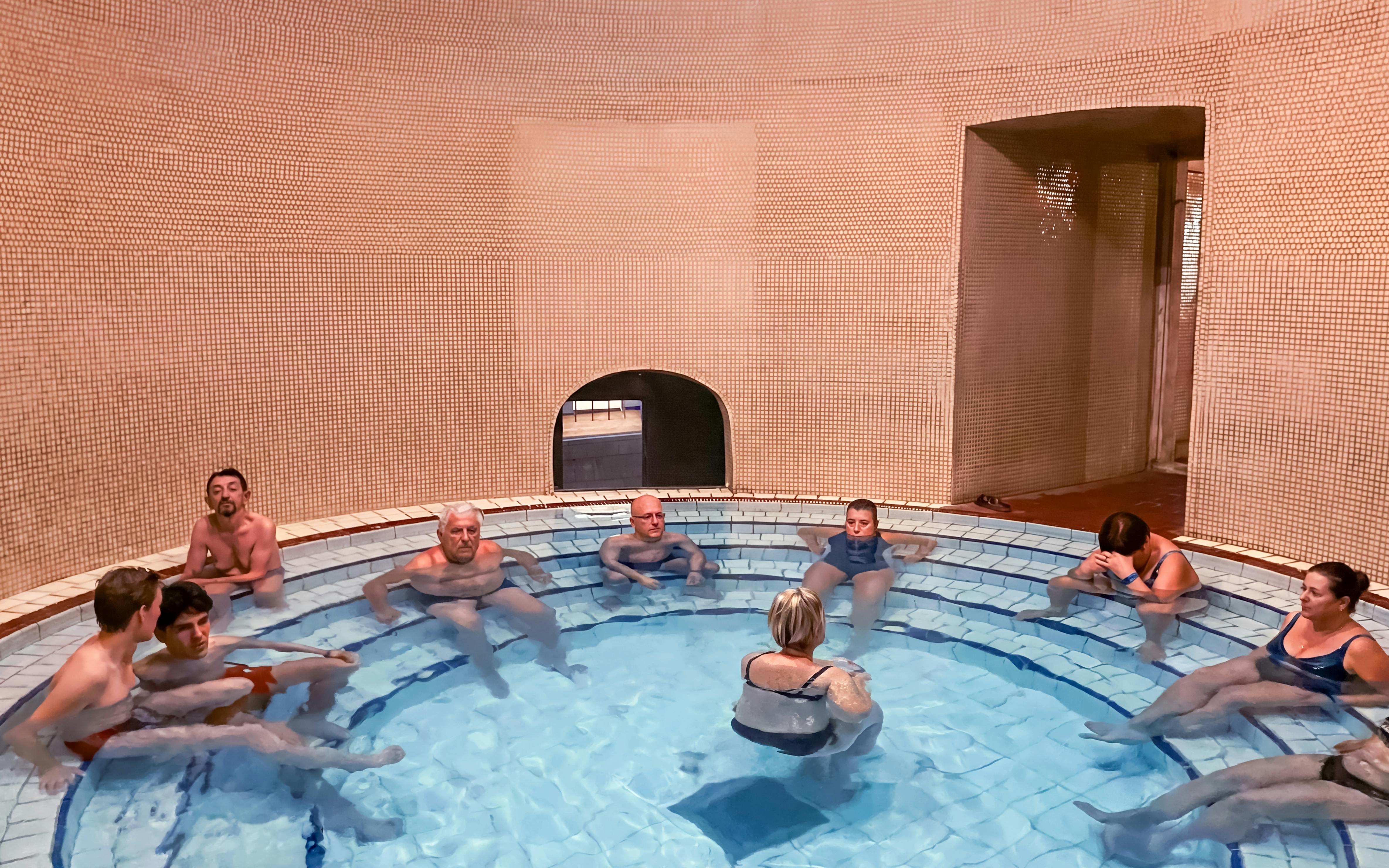 Visitors relaxing in a thermal bath at Lukács Spa, Budapest.