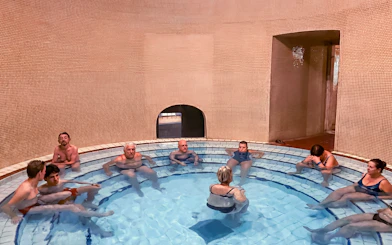 Visitors relaxing in a thermal bath at Lukács Spa, Budapest.