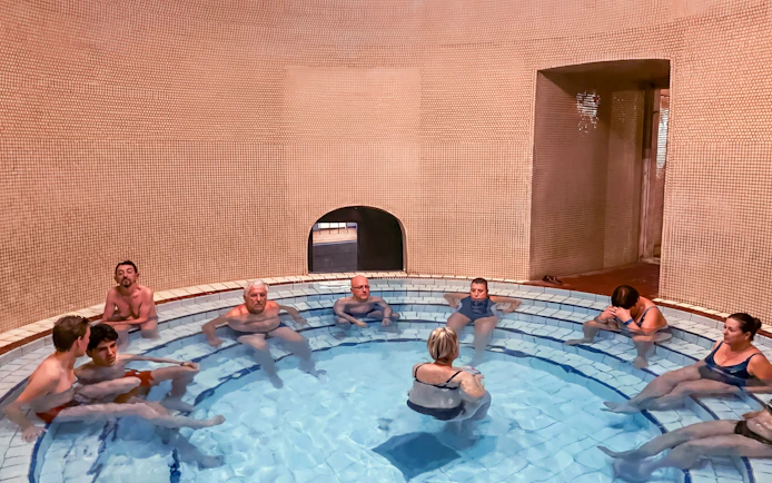 Visitors relaxing in a thermal bath at Lukács Spa, Budapest.