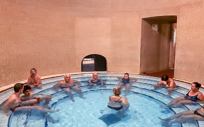 Visitors relaxing in a thermal bath at Lukács Spa, Budapest.