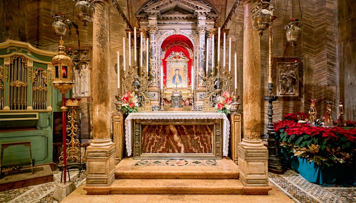 St. Mark's Basilica facade with intricate mosaics and arches in Venice, Italy.
