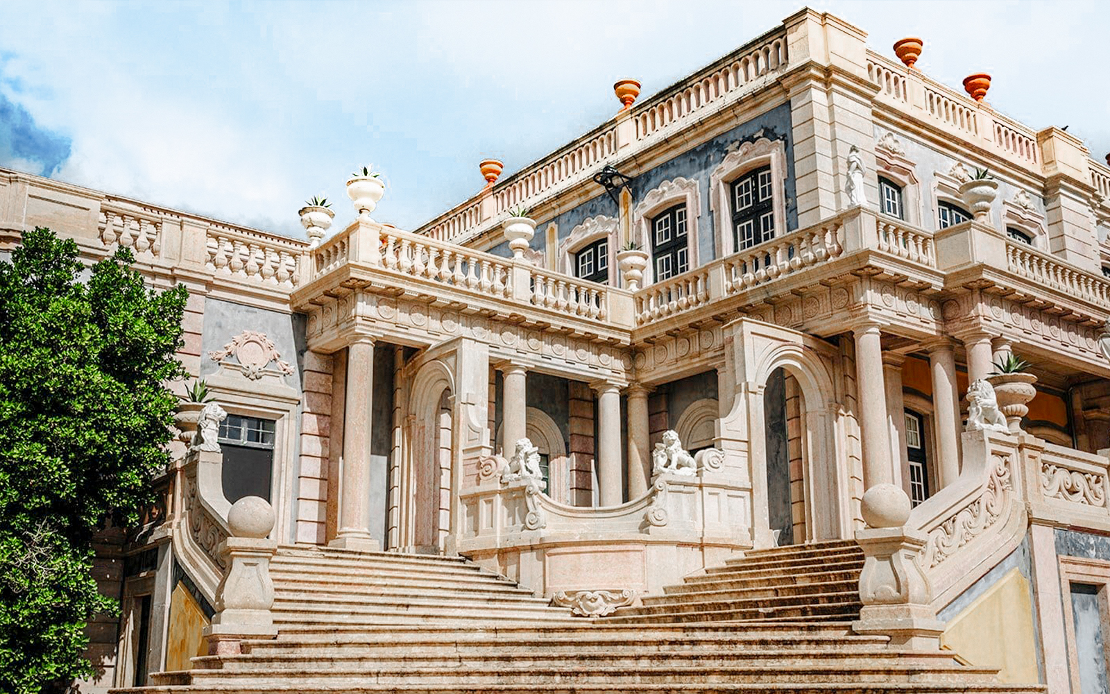 Robillion Pavilion at National Palace of Queluz with ornate staircase and sculptures.