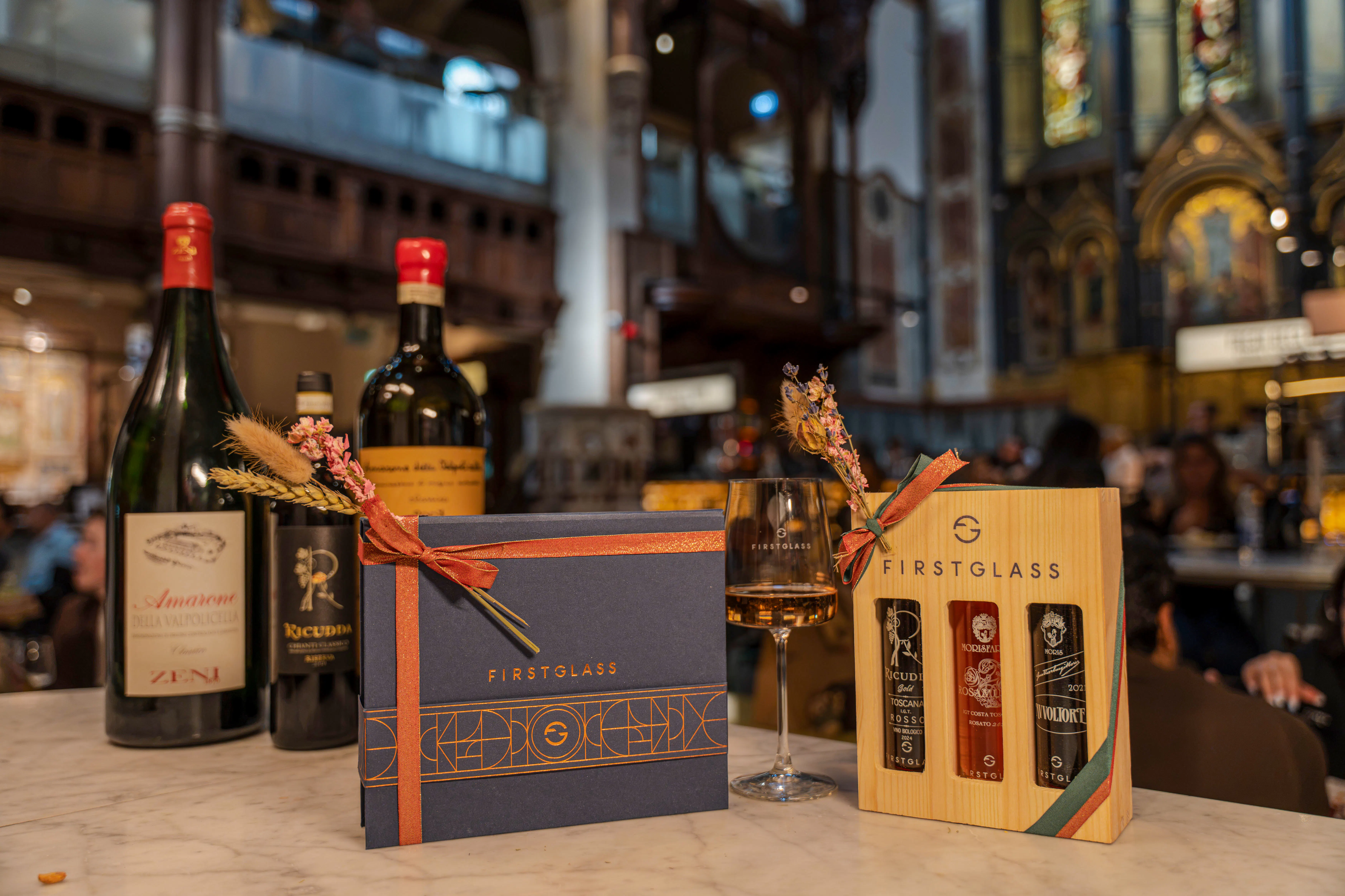Wine bottles and gift boxes on a table at a private Italian wine event in Mayfair, London.
