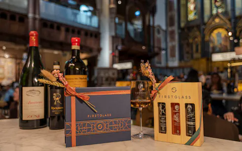 Wine bottles and gift boxes on a table at a private Italian wine event in Mayfair, London.
