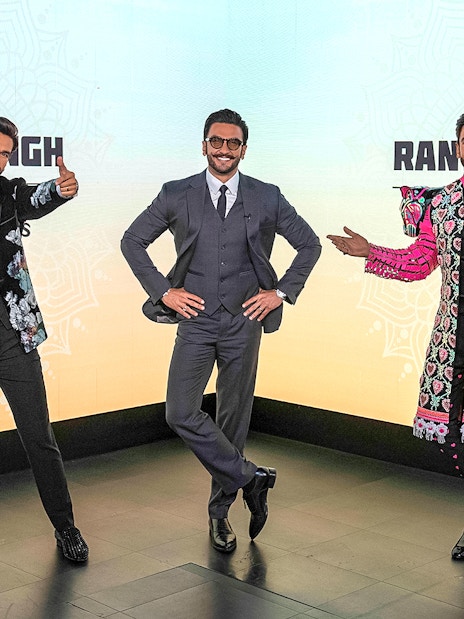 Wax figures of a celebrity in various outfits at Madame Tussauds Singapore.