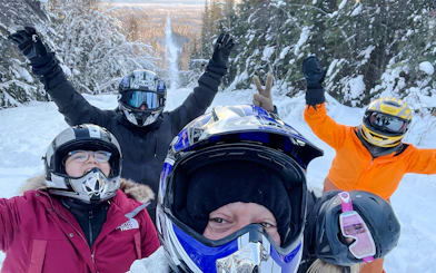 Group enjoying snowmobile tour in snowy forest near Fairbanks, Alaska.