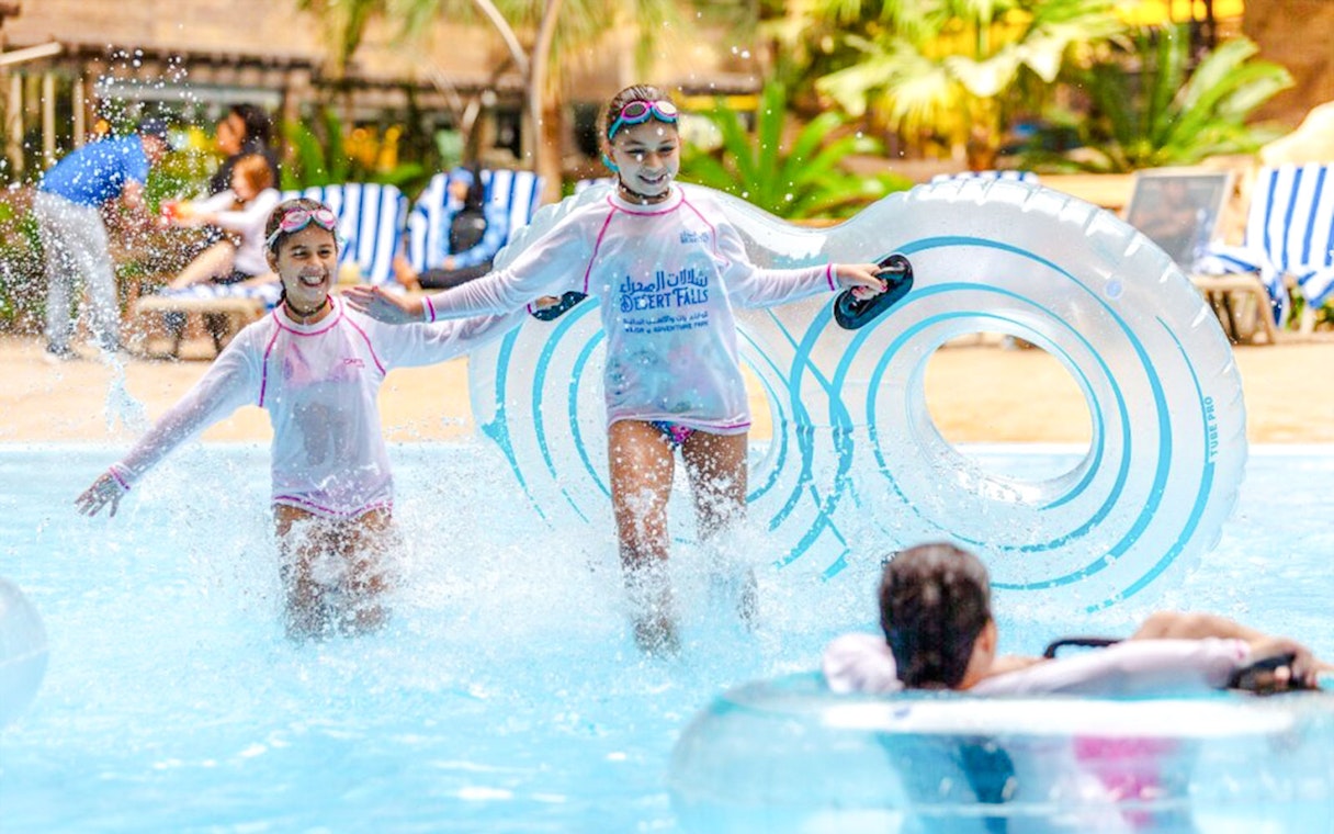 Children enjoying water activities at a Doha water park.