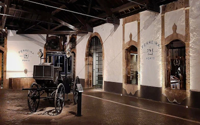 Ferreira Port Wine Cellar interior with vintage carriage, Porto.