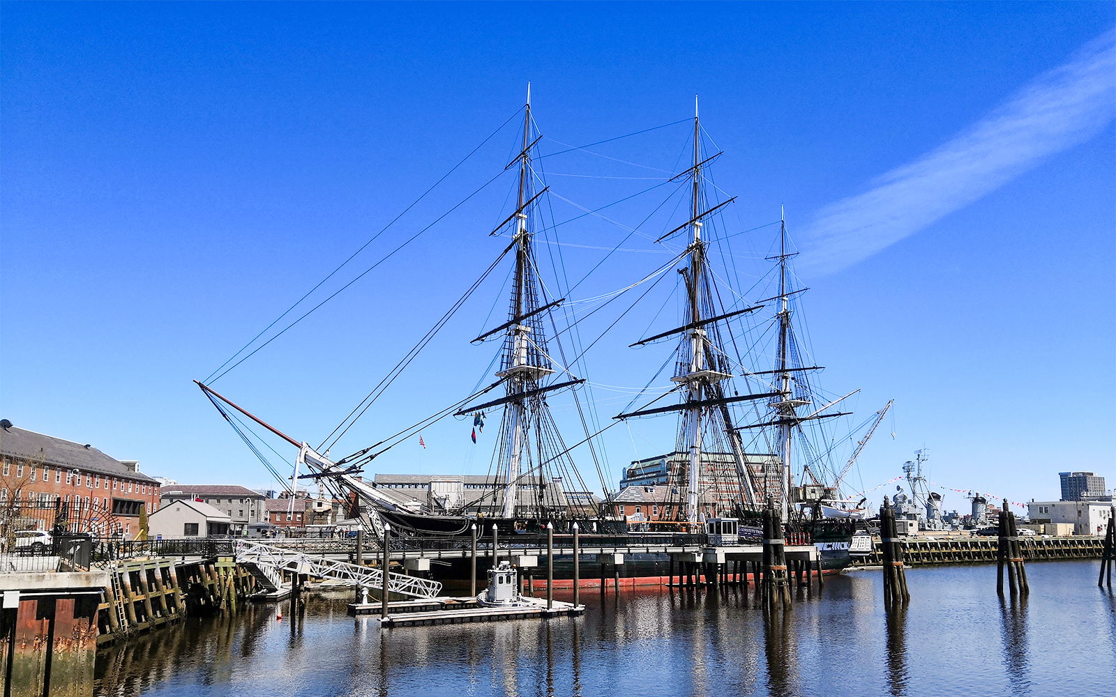 USS Constitution docked at Boston Navy Yard on a sunny day.
