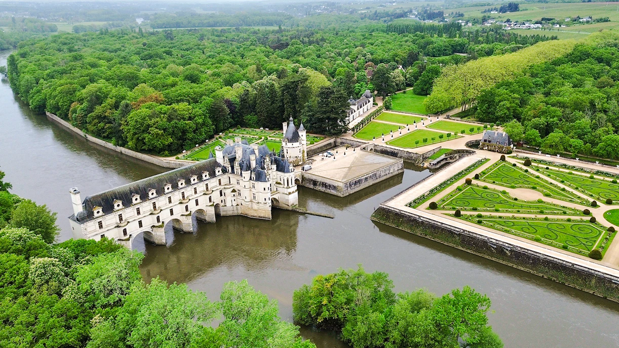 Chenonceau Castle aerial view with gardens and river in Loire Valley, France.