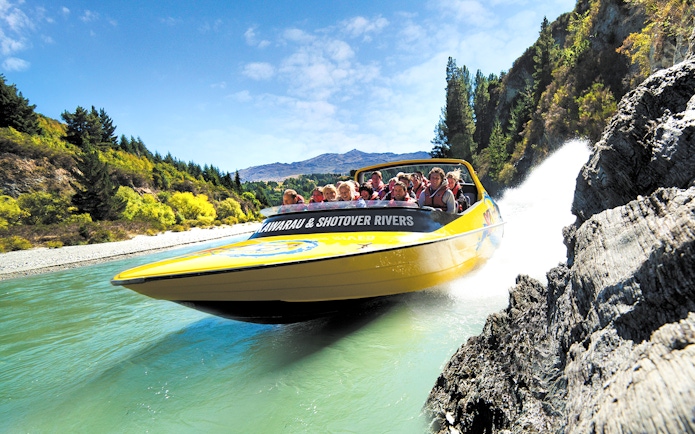 Jet boat speeding through Kawarau and Shotover Rivers in Queenstown, New Zealand.