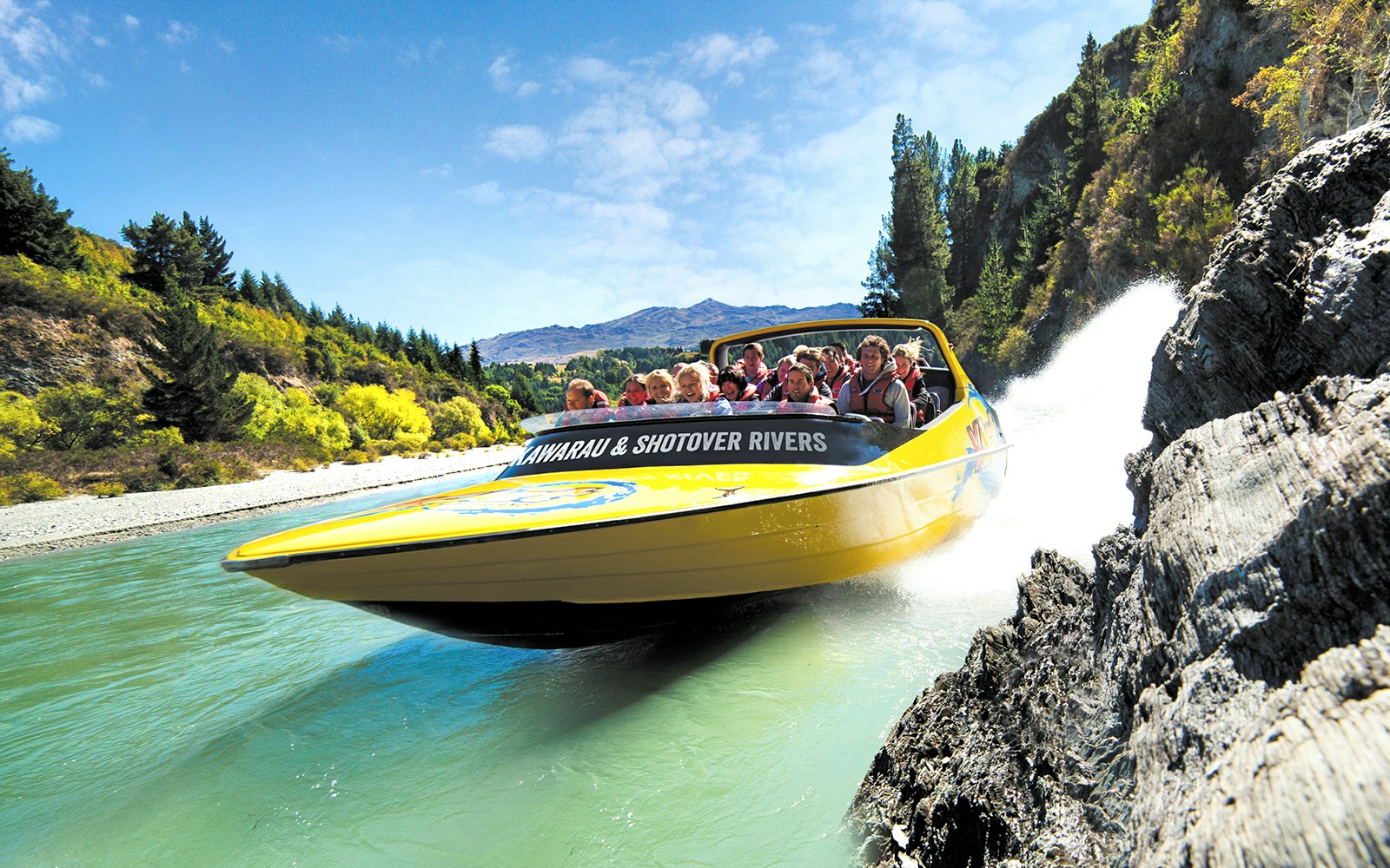 Jet boat speeding through Kawarau and Shotover Rivers in Queenstown, New Zealand.