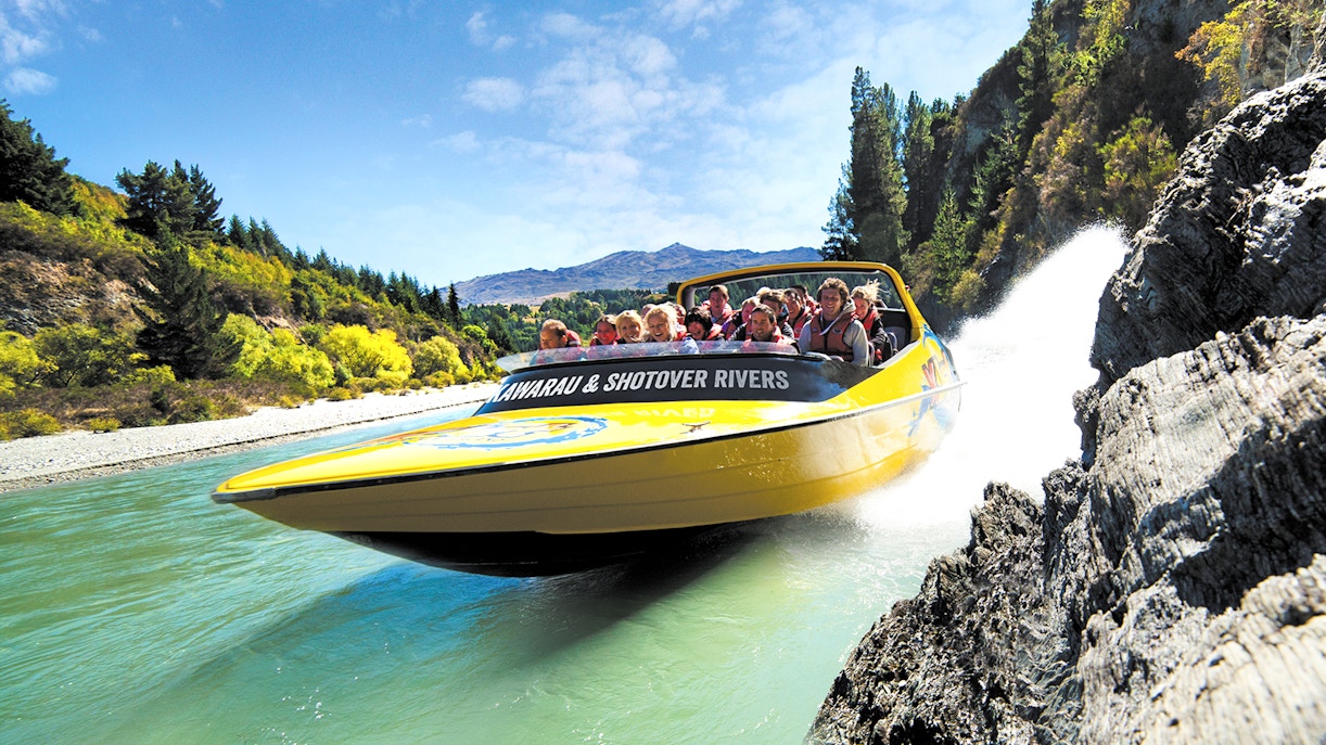 Jet boat speeding through Kawarau and Shotover Rivers in Queenstown, New Zealand.