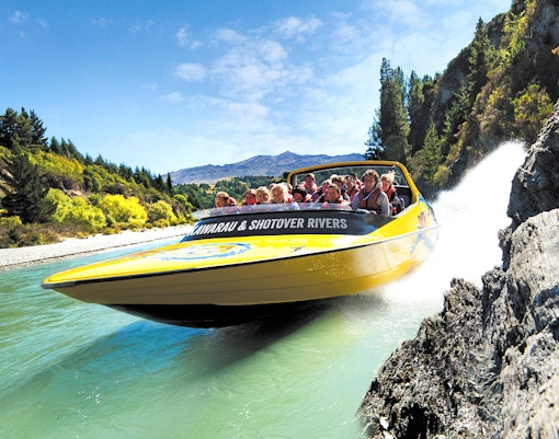 Jet boat speeding through Kawarau and Shotover Rivers in Queenstown, New Zealand.