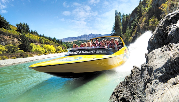 Jet boat speeding through Kawarau and Shotover Rivers in Queenstown, New Zealand.
