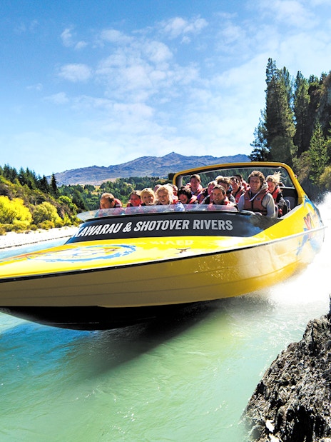 Jet boat speeding through Kawarau and Shotover Rivers in Queenstown, New Zealand.