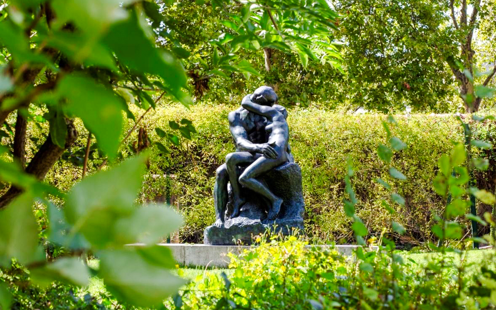 Rodin Museum sculpture surrounded by lush greenery.