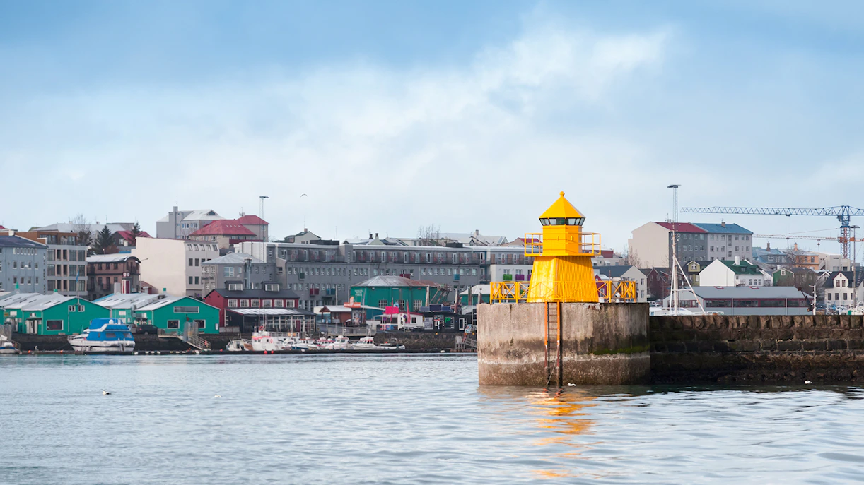 Lighthouse at Reykjavik port entrance viewed from a RIB speedboat, Iceland.