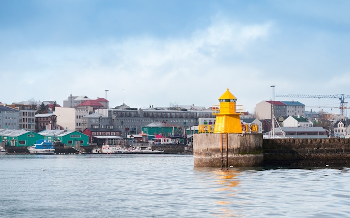 Lighthouse at Reykjavik port entrance viewed from a RIB speedboat, Iceland.