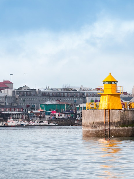 Lighthouse at Reykjavik port entrance viewed from a RIB speedboat, Iceland.
