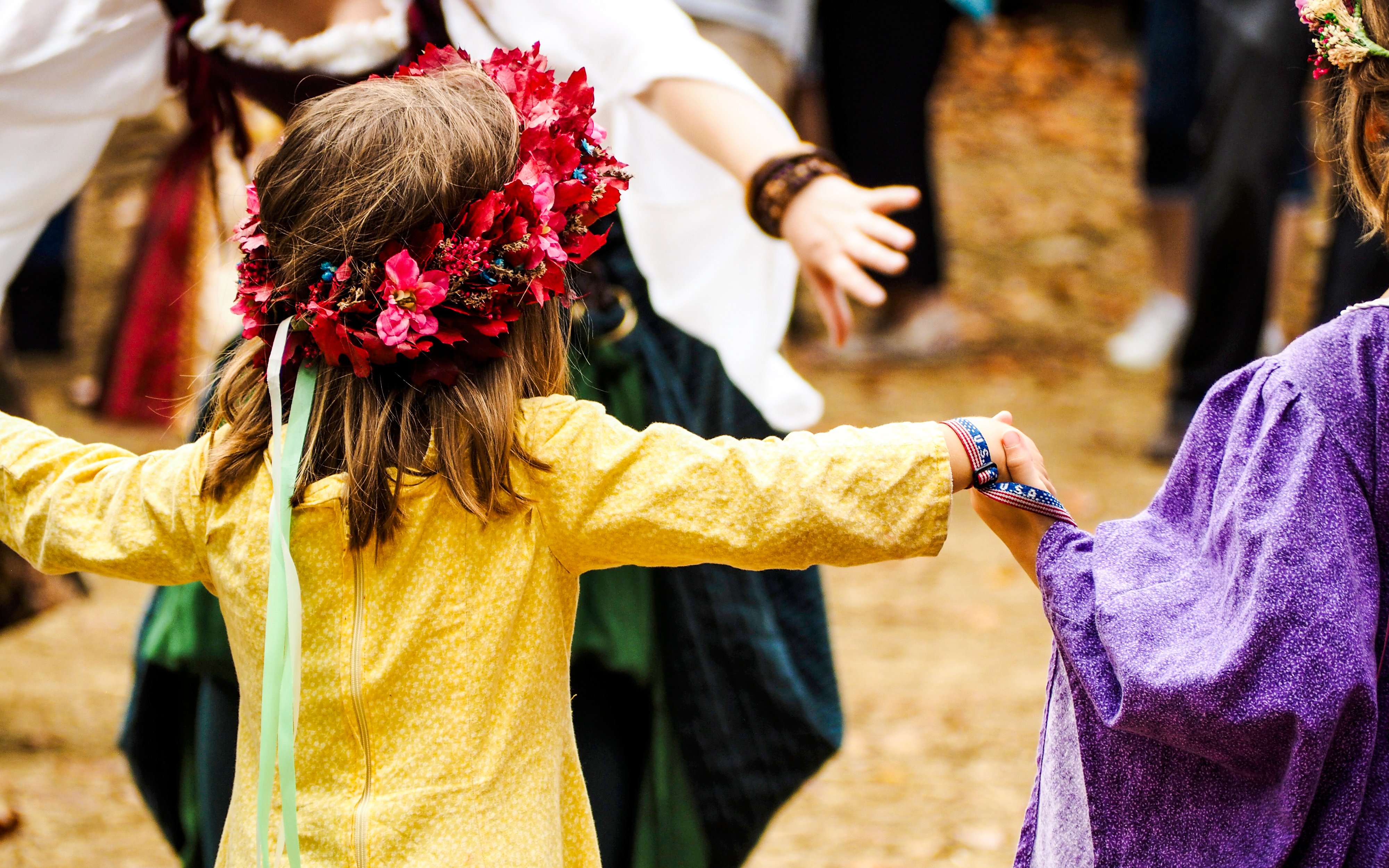 Children holding hands at Schwangau Village Maypole Festival.
