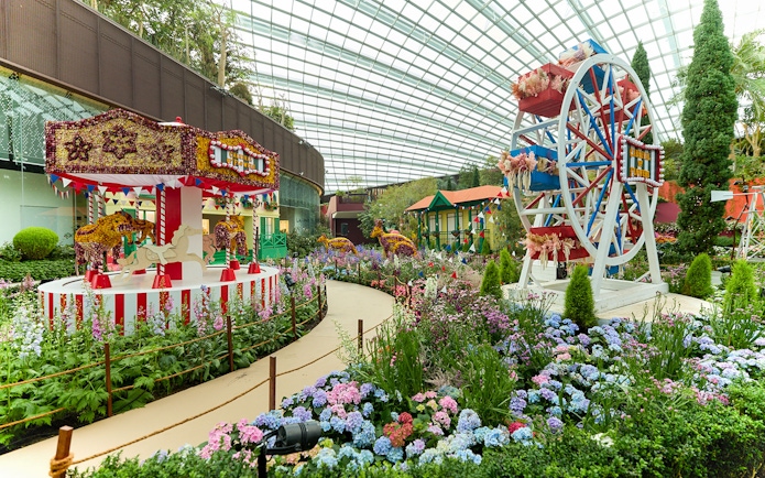 Carousel and Ferris wheel in flower garden at Gardens by the Bay, Singapore.