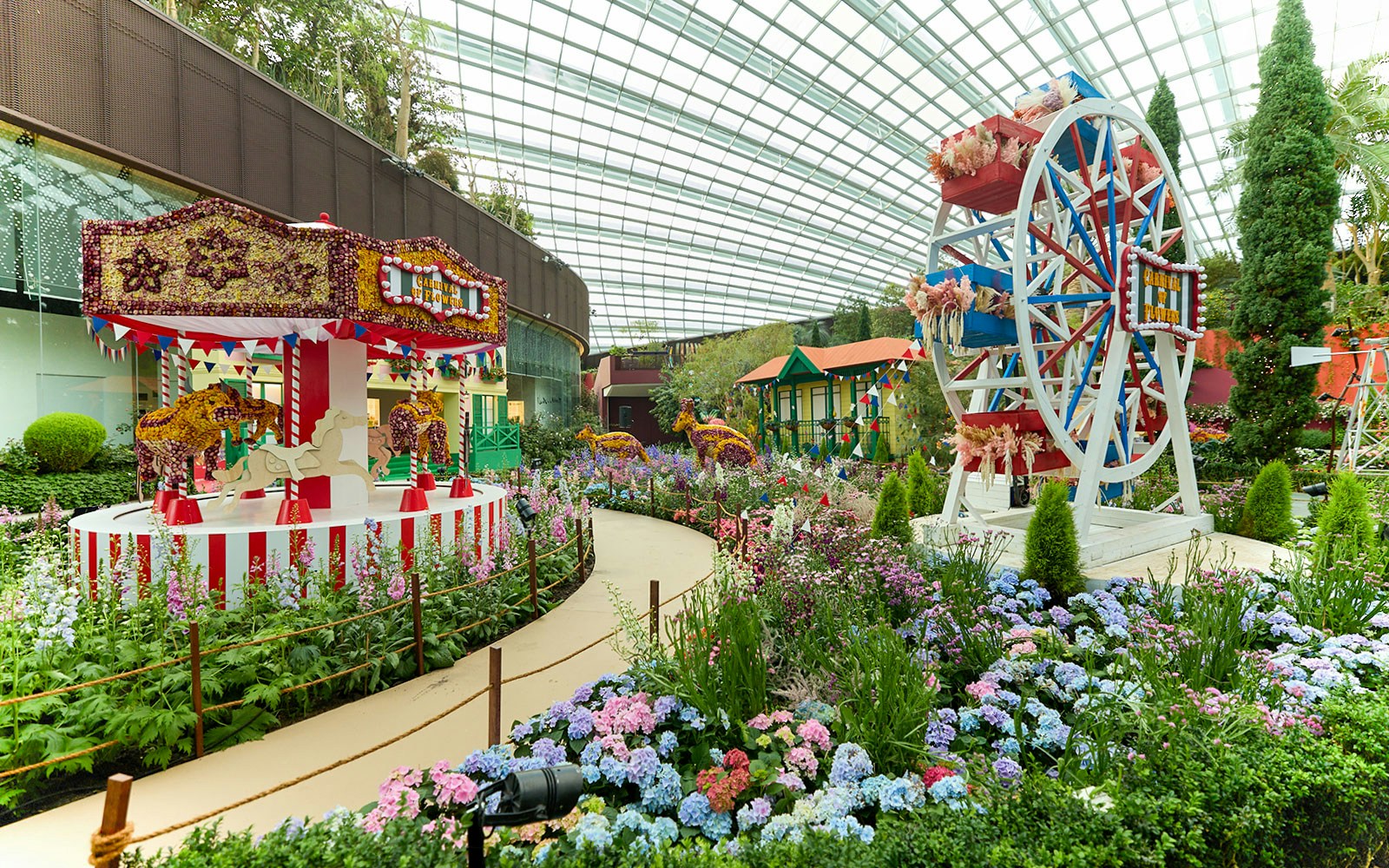 Carousel and Ferris wheel in flower garden at Gardens by the Bay, Singapore.