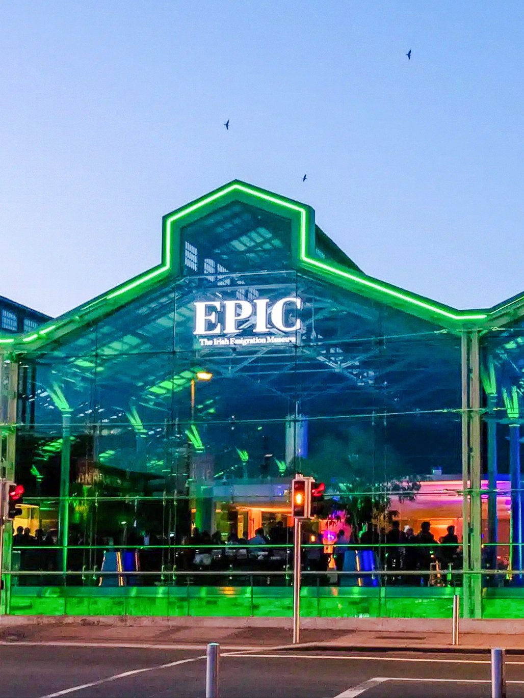 EPIC Museum Dublin glass facade illuminated at dusk.