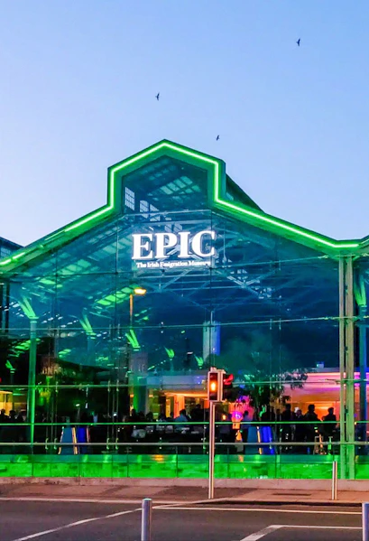 EPIC Museum Dublin glass facade illuminated at dusk.
