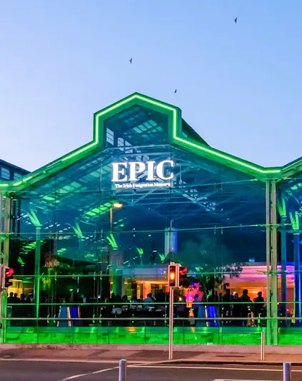 EPIC Museum Dublin glass facade illuminated at dusk.