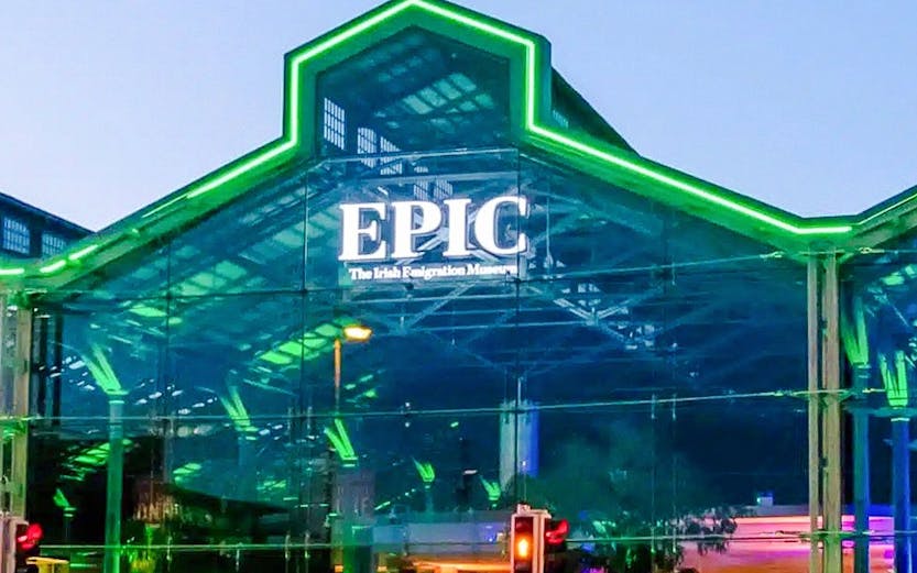 EPIC Museum Dublin glass facade illuminated at dusk.