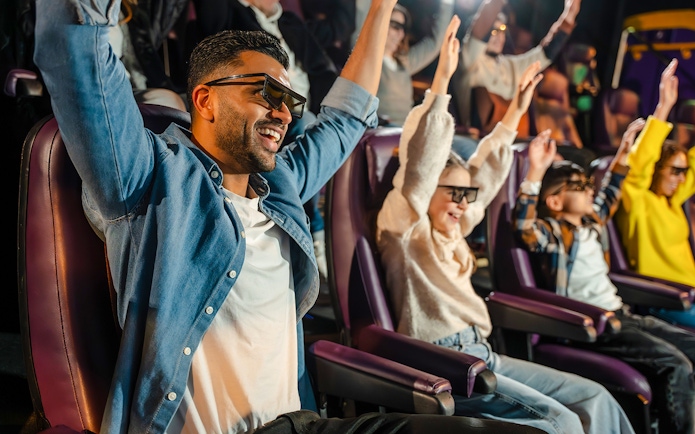 Visitors enjoying 4D Chocolate Adventure at Cadbury World with 3D glasses.