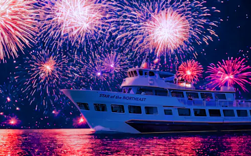 Cruise ship under vibrant fireworks display on 4th of July.