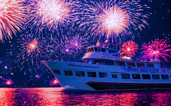 Cruise ship under vibrant fireworks display on 4th of July.