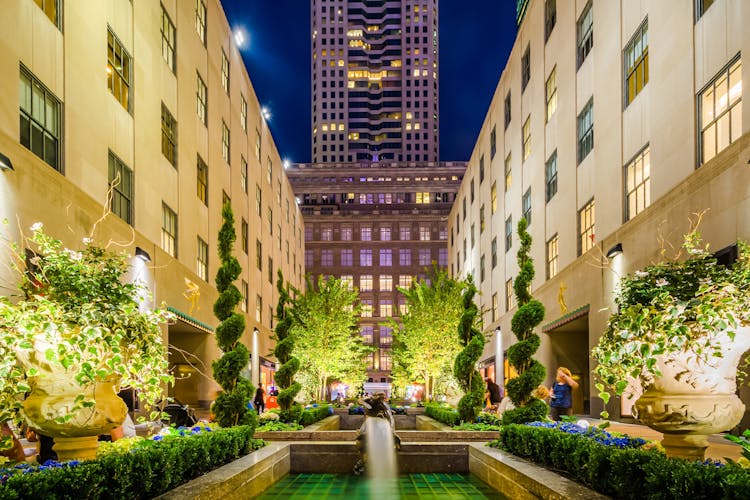 Channel Gardens at Rockefeller Center, New York City, illuminated at night with fountains and greenery.