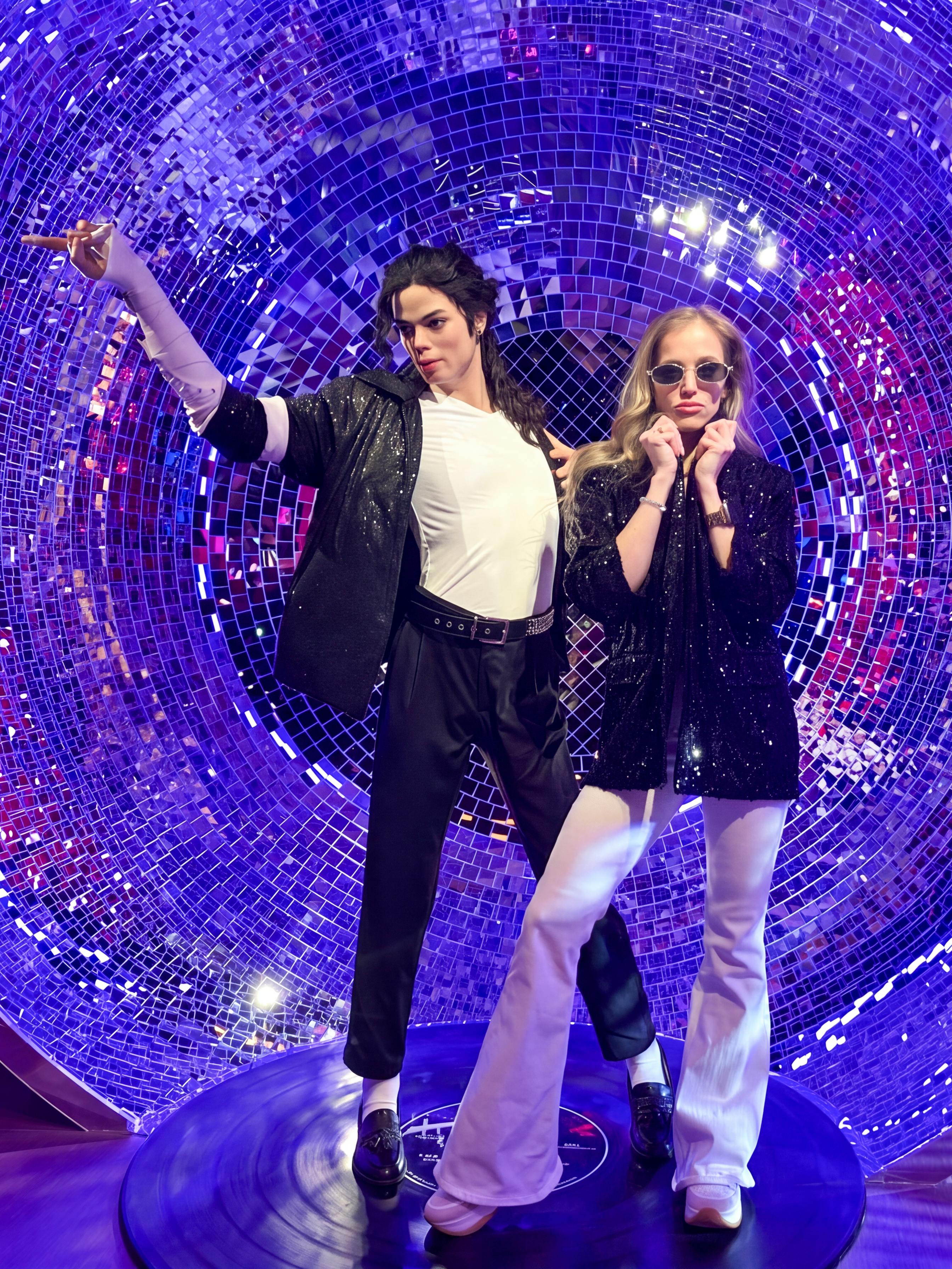Wax figures in a disco-themed setting at Madame Tussauds Budapest.