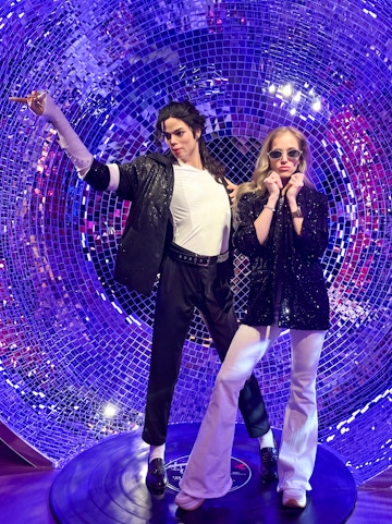 Wax figures in a disco-themed setting at Madame Tussauds Budapest.