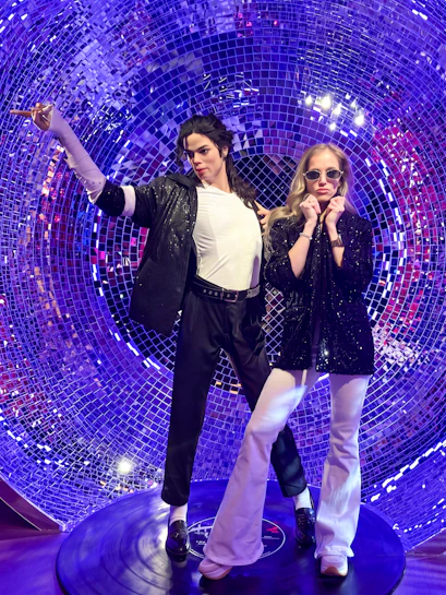 Wax figures in a disco-themed setting at Madame Tussauds Budapest.