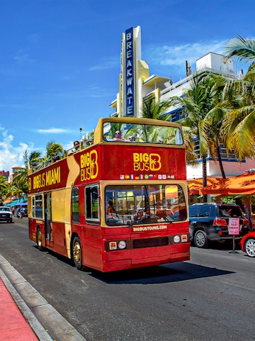 Big Bus Miami tour passing Breakwater Hotel on Ocean Drive.