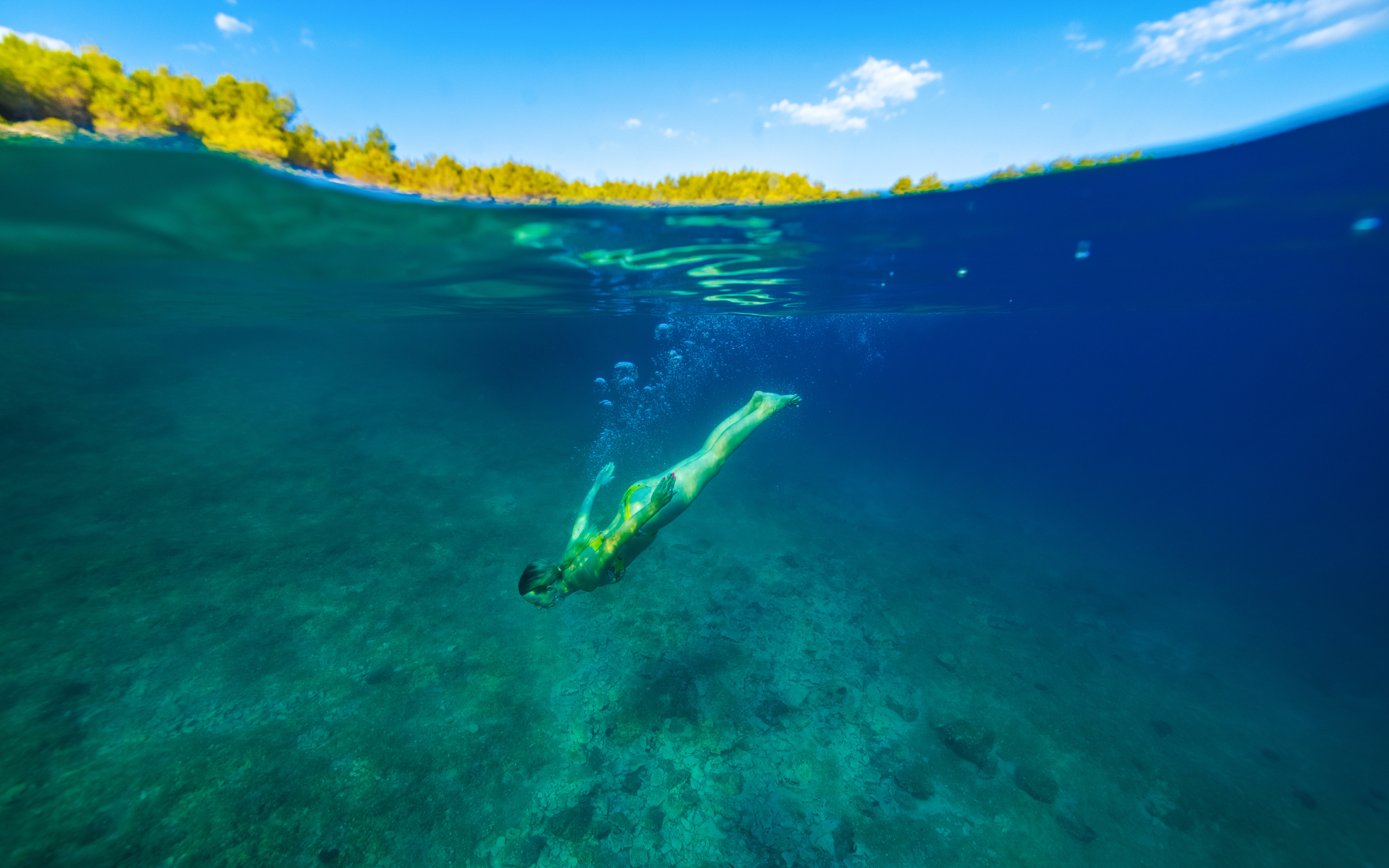 Girl diving underwater in the Adriatic Sea near Hvar island, Croatia.