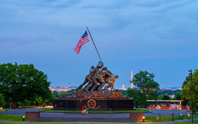 Iwo Jima Memorial with Washington Monument in the background during a moonlight bus tour in Washington DC.