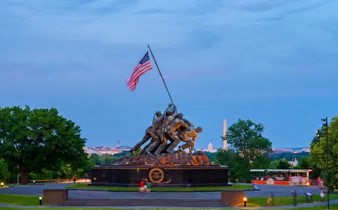 Iwo Jima Memorial with Washington Monument in the background during a moonlight bus tour in Washington DC.